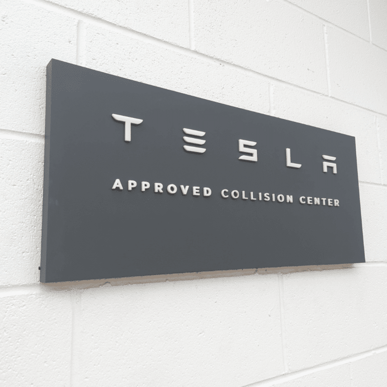 Tesla Certified signage at CMS Auto Body Shop Houston